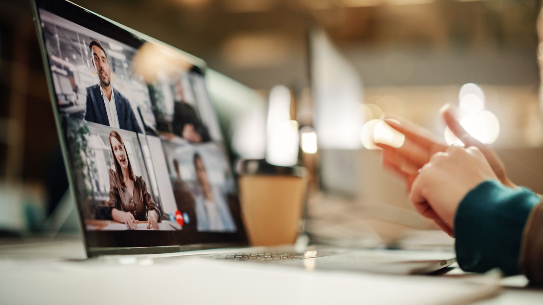 A video meeting in progress on a laptop.